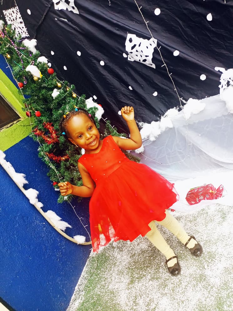 A pupil in a red dress at the Christmas Let It Snow display