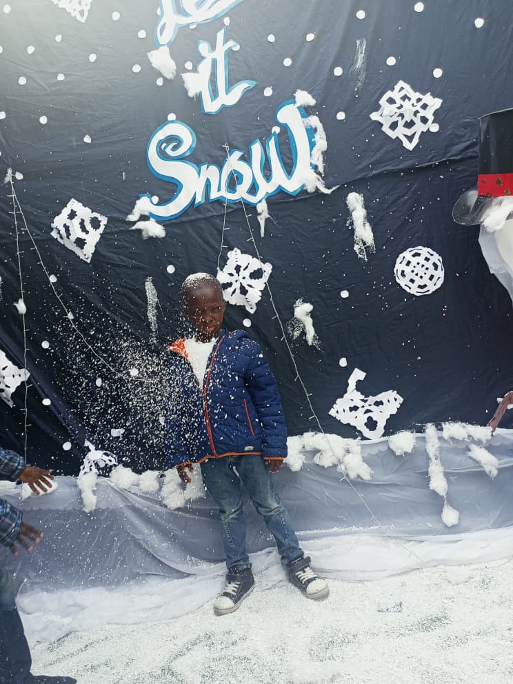 A pupil playing in artificial snow at the Let It Snow display