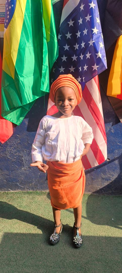 A pupil in traditional attire for Global Tour Passport Day