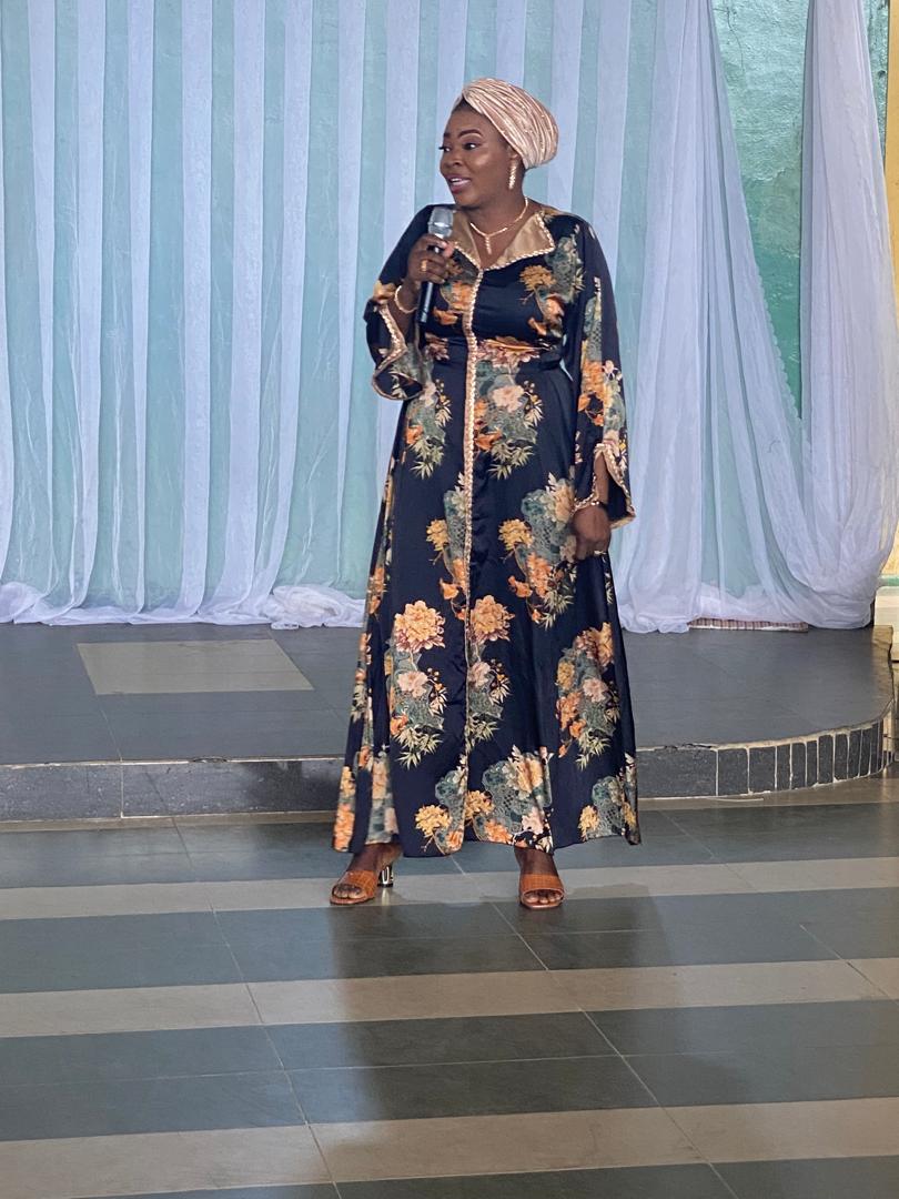 A member of staff addressing guests at the graduation ceremony