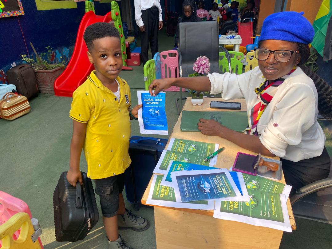 A pupil at the check-in desk with his Global Tour Passport
