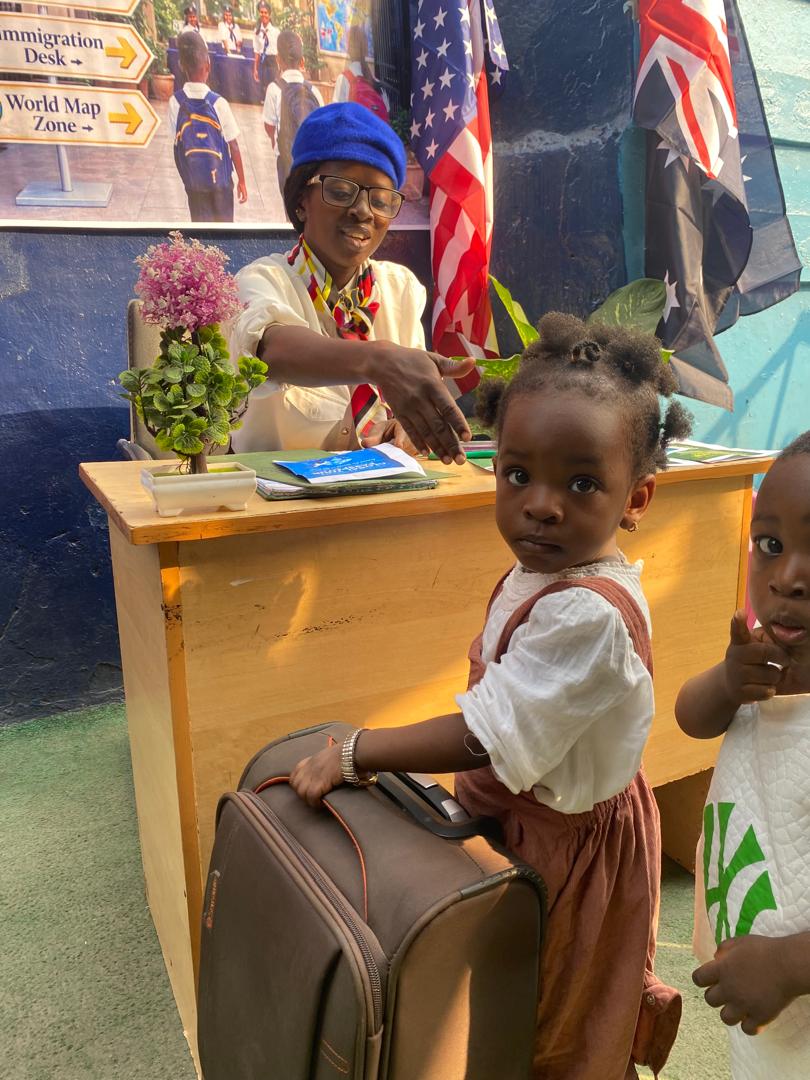 Toddlers with luggage at the Global Tour Passport desk