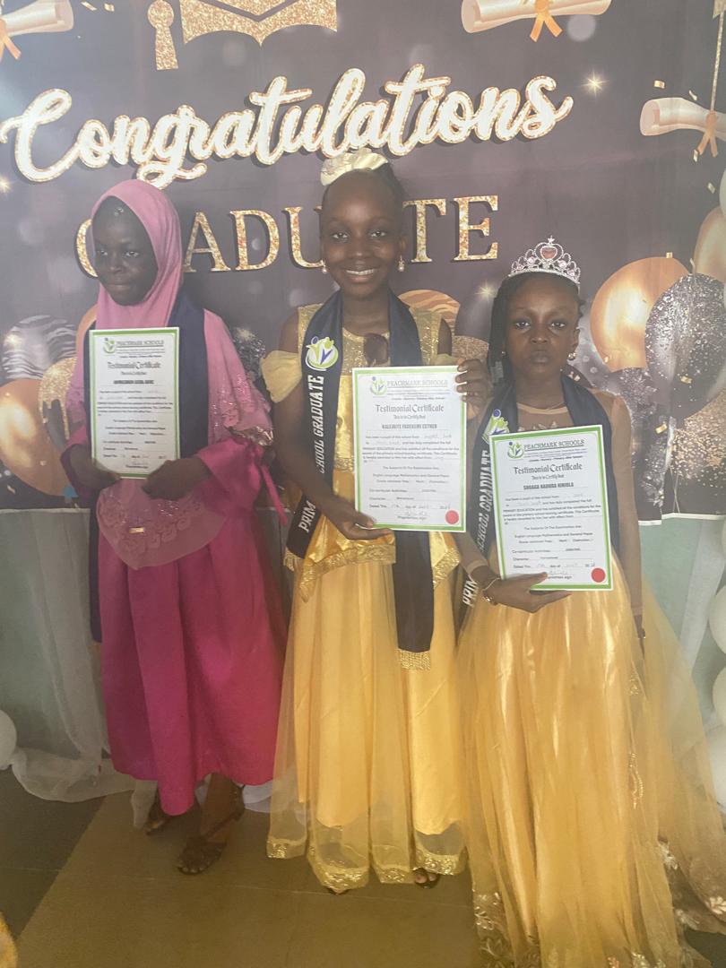 Graduates holding their testimonial certificates